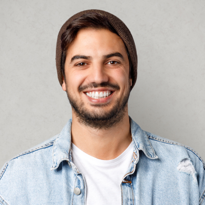 young smiling man with beard and brown beanie
